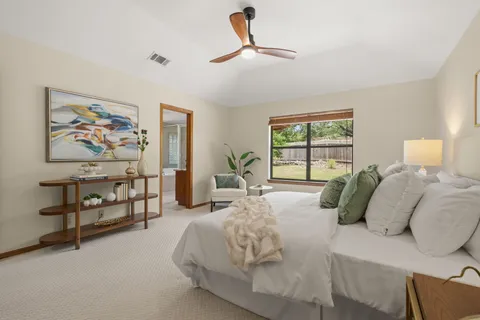 a bedroom with a large bed and a window