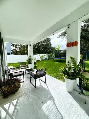 a building outdoor space with patio furniture and potted plants