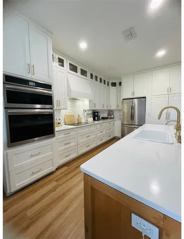 a kitchen with refrigerator and cabinets