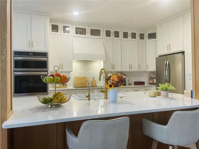 a kitchen with a sink cabinets and appliances