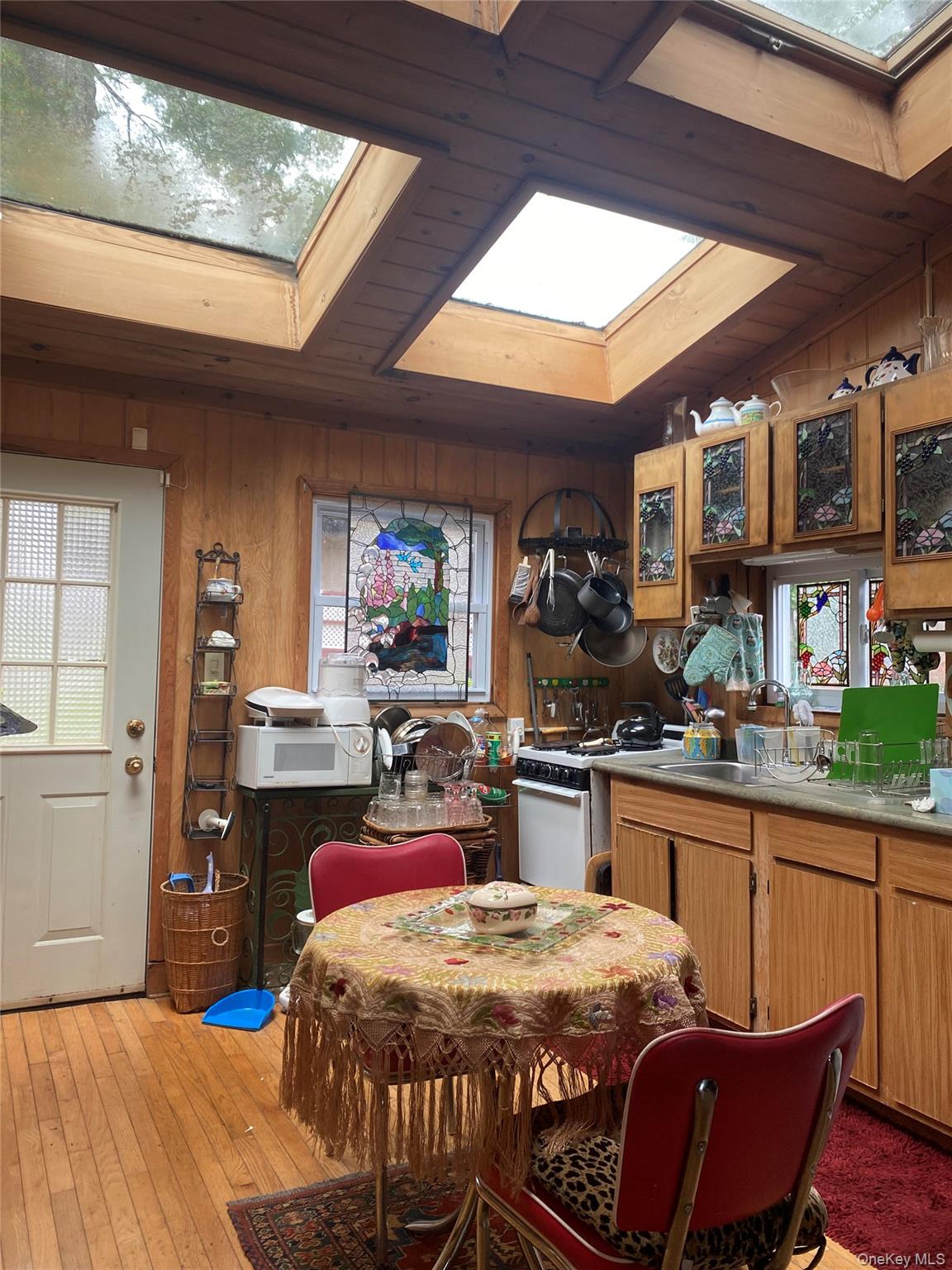 1192 Highway 52, Unit 18 Loch Sheldrake, NY 12759 - Photo 3 of 16 a kitchen with a stove a sink and a refrigerator