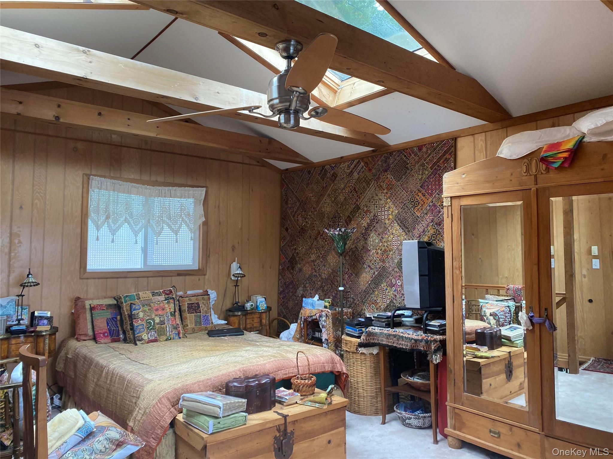 1192 Highway 52, Unit 18 Loch Sheldrake, NY 12759 - Photo 5 of 16 a bedroom with furniture and a large window