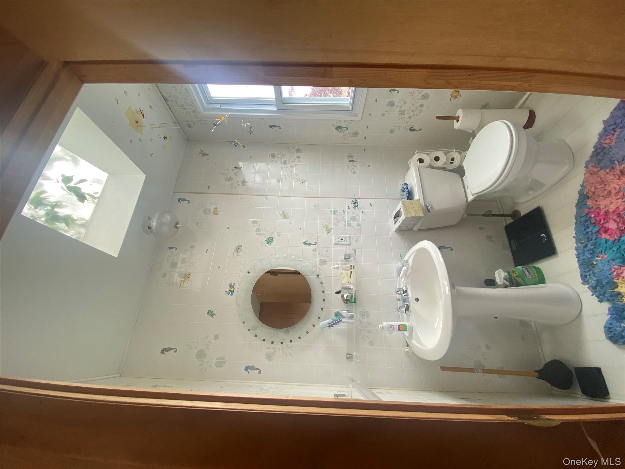 1192 Highway 52, Unit 18 Loch Sheldrake, NY 12759 - Photo 10 of 16 a bathroom with a toilet sink and mirror