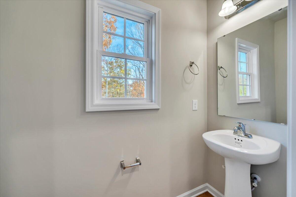 1109 Niagara Road Vinton, VA 24179 - Photo 13 of 25 a bathroom with a sink a mirror and a window