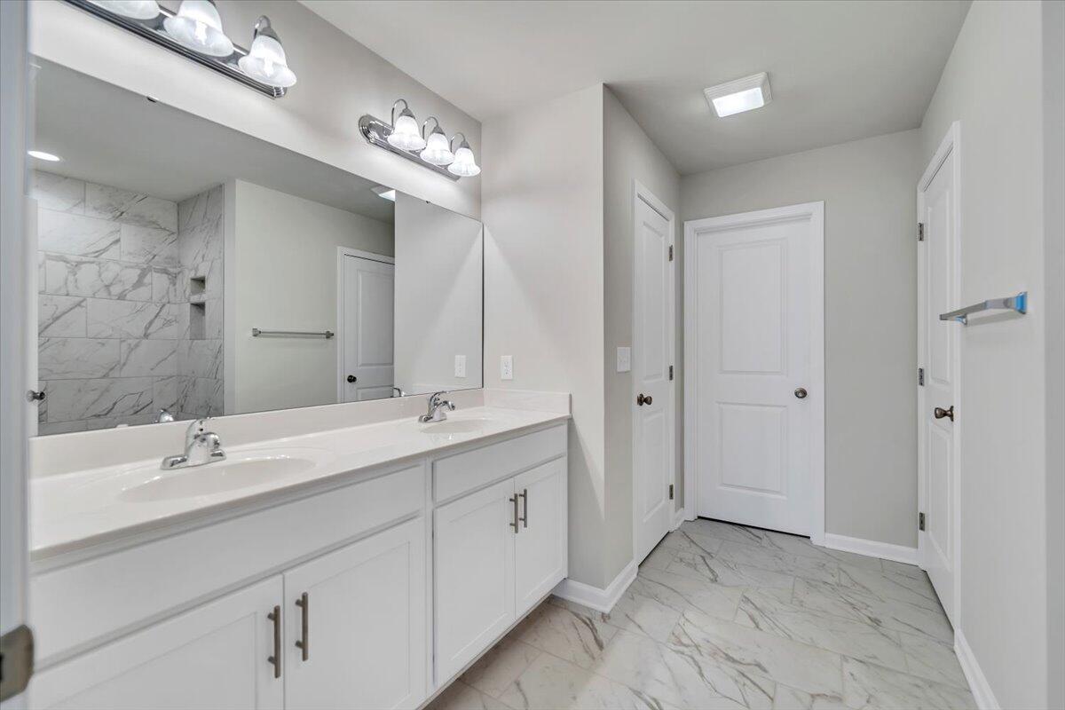 1109 Niagara Road Vinton, VA 24179 - Photo 17 of 25 a bathroom with a double vanity sink and mirror