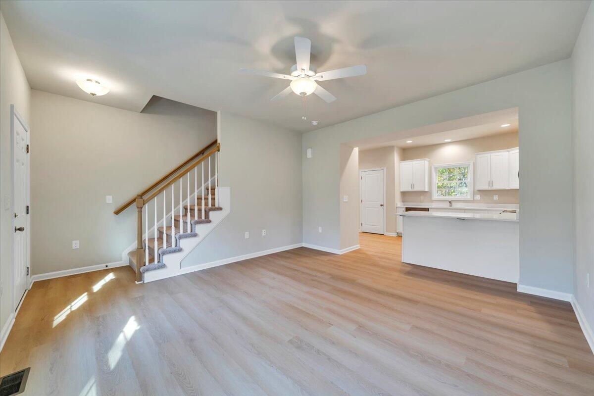 1109 Niagara Road Vinton, VA 24179 - Photo 3 of 25 a view of an empty room with wooden floor and a kitchen view