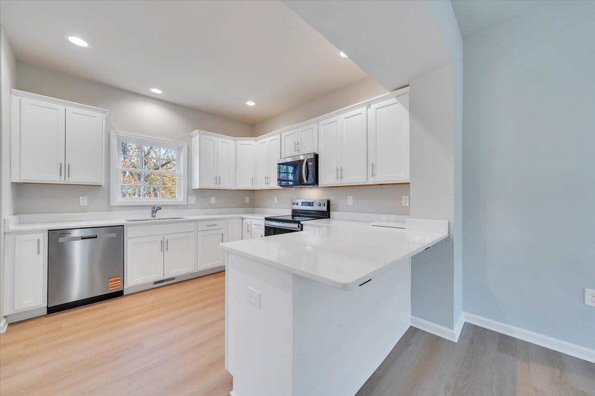 1109 Niagara Road Vinton, VA 24179 - Photo 6 of 25 a kitchen with a sink white cabinets and stainless steel appliances