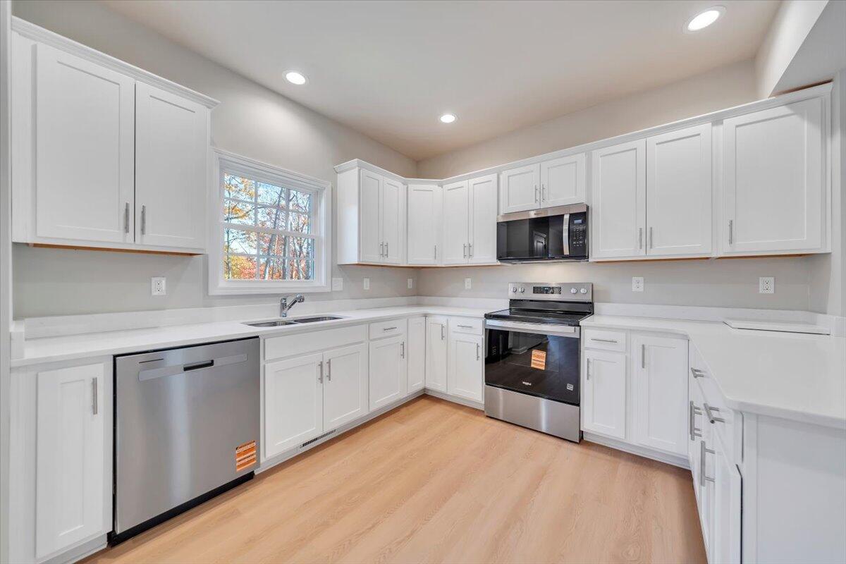 1109 Niagara Road Vinton, VA 24179 - Photo 7 of 25 a kitchen with granite countertop white cabinets and white appliances