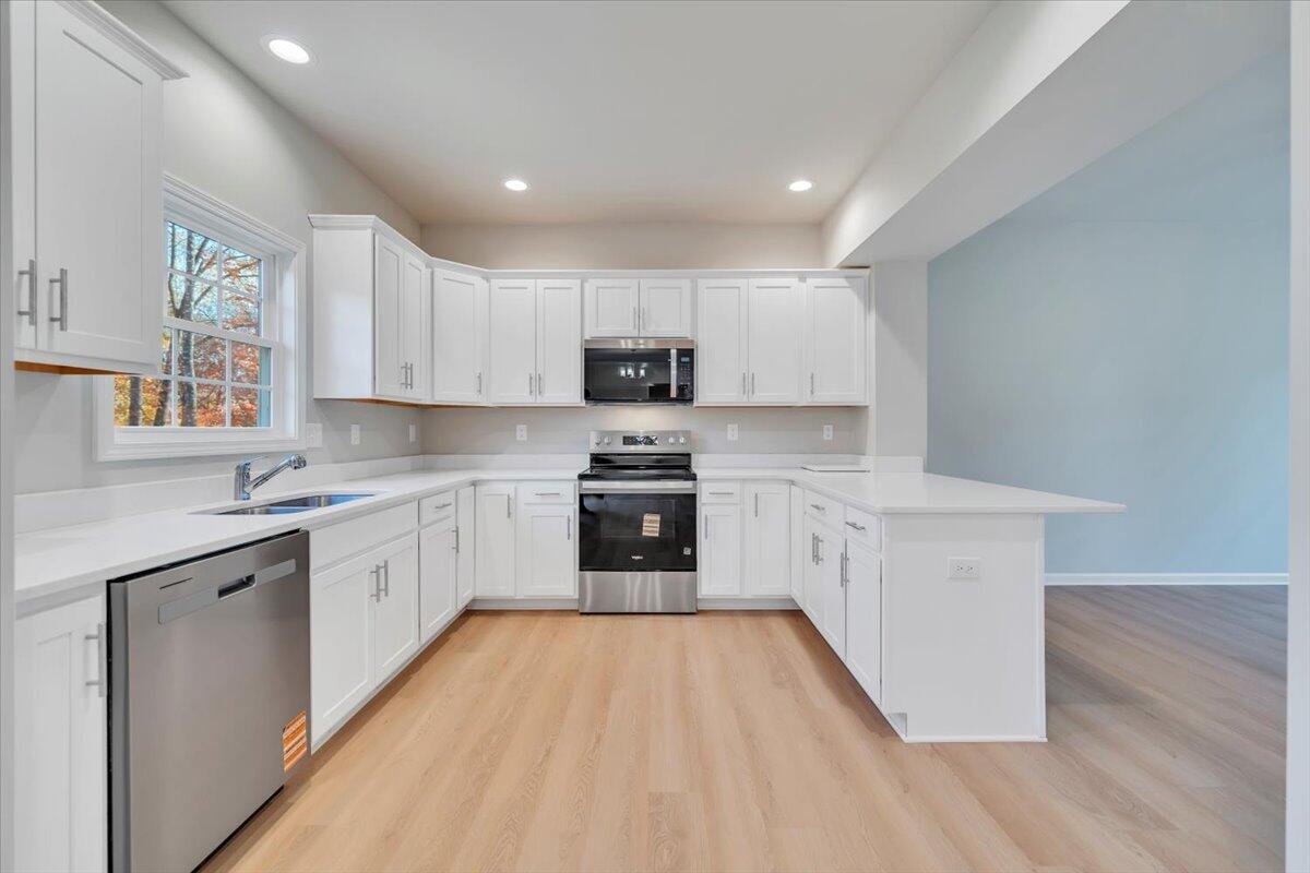 1109 Niagara Road Vinton, VA 24179 - Photo 8 of 25 a kitchen with granite countertop white cabinets and stainless steel appliances