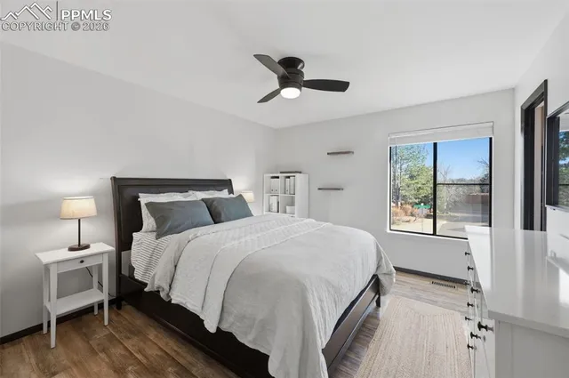 a spacious bedroom with a bed and a window