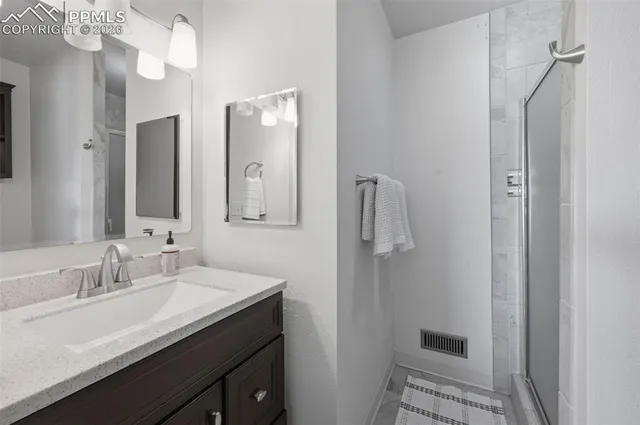 a bathroom with a sink vanity and a mirror