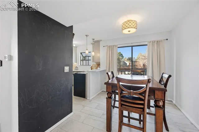 a view of a dining room with furniture and a window