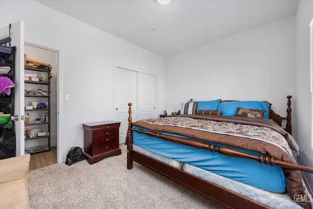 a spacious bedroom with a bed and a window