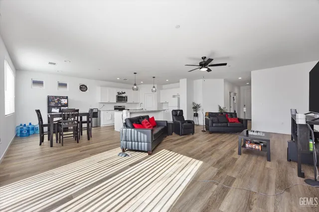 a living room with furniture and a wooden floor