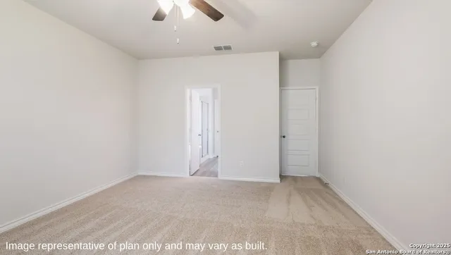 an empty room with ceiling fan and window