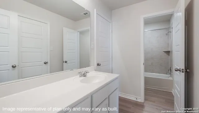 a bathroom with a sink and a mirror