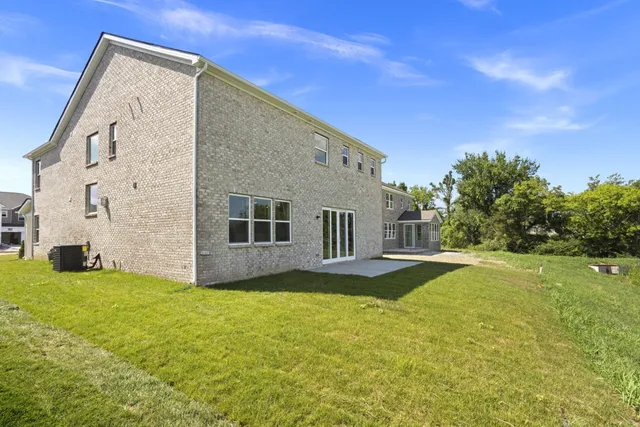 a house view with swimming pool in front of it