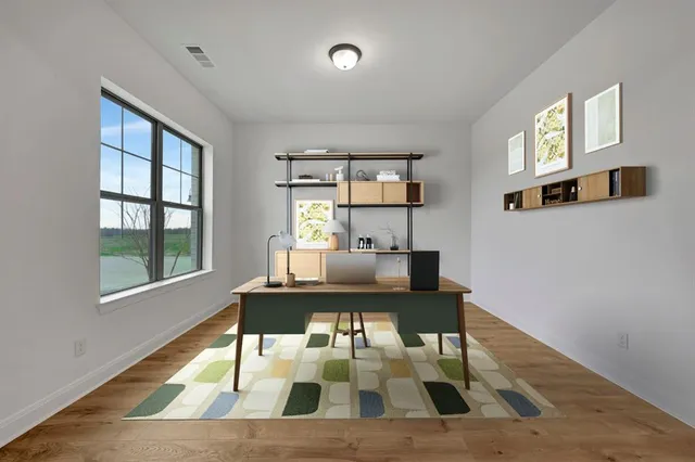 a living room with furniture a window and a table
