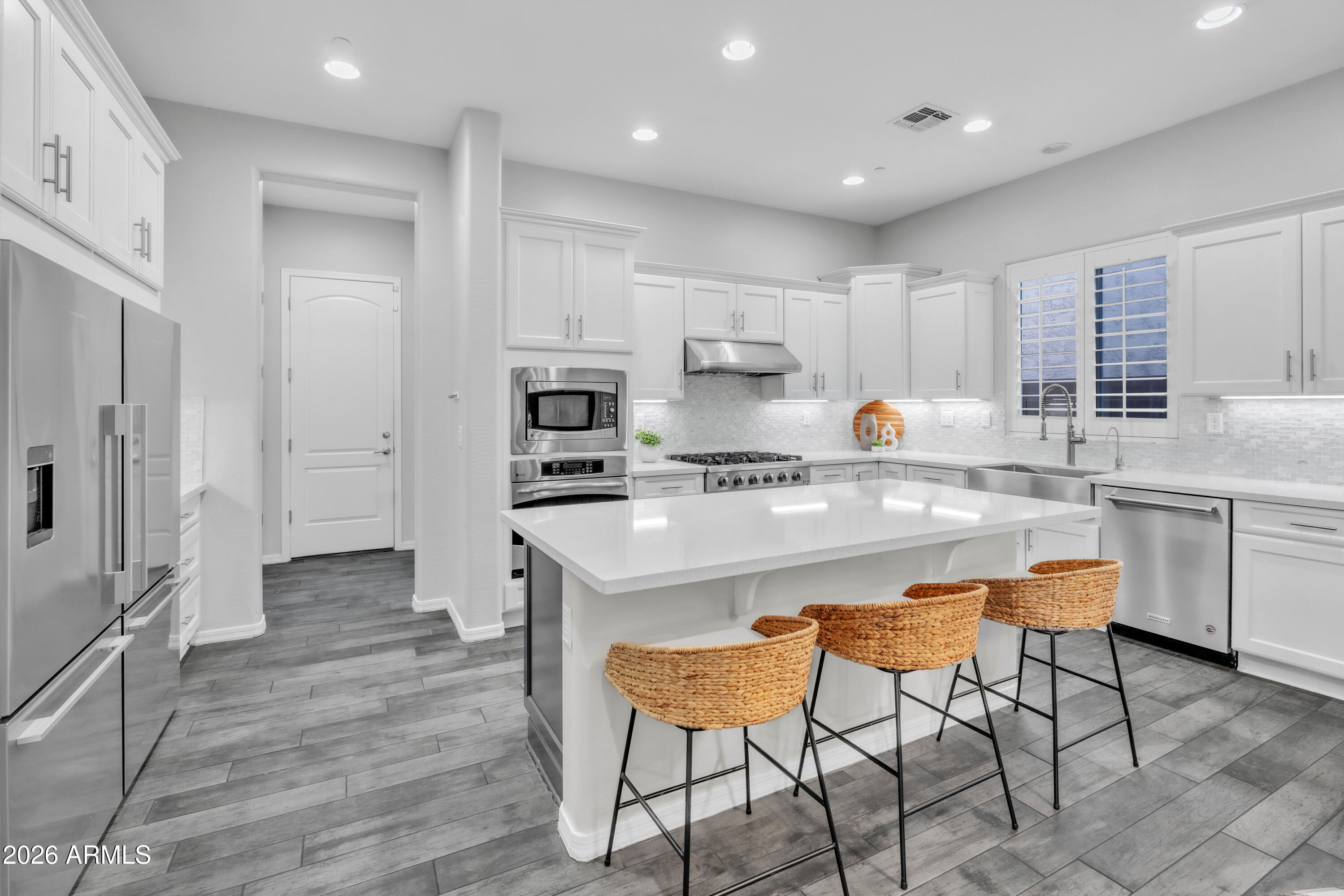 1615 West Red Fox Road Phoenix, AZ 85085 - Photo 25 of 64 a kitchen with stainless steel appliances kitchen island granite countertop a refrigerator and a stove top oven