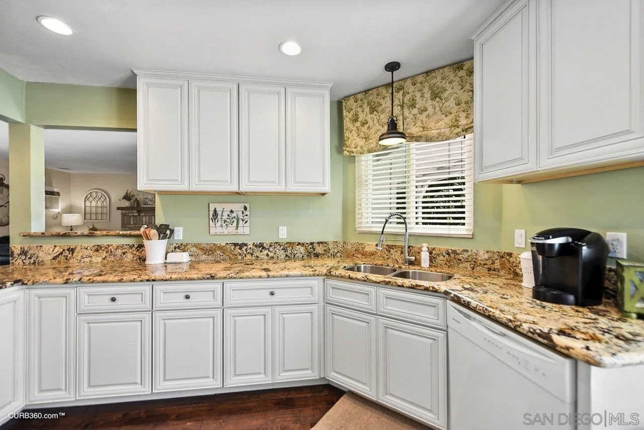 13429 Standish Drive Poway, CA 92064 - Photo 11 of 30 a kitchen with granite countertop a sink window and cabinets