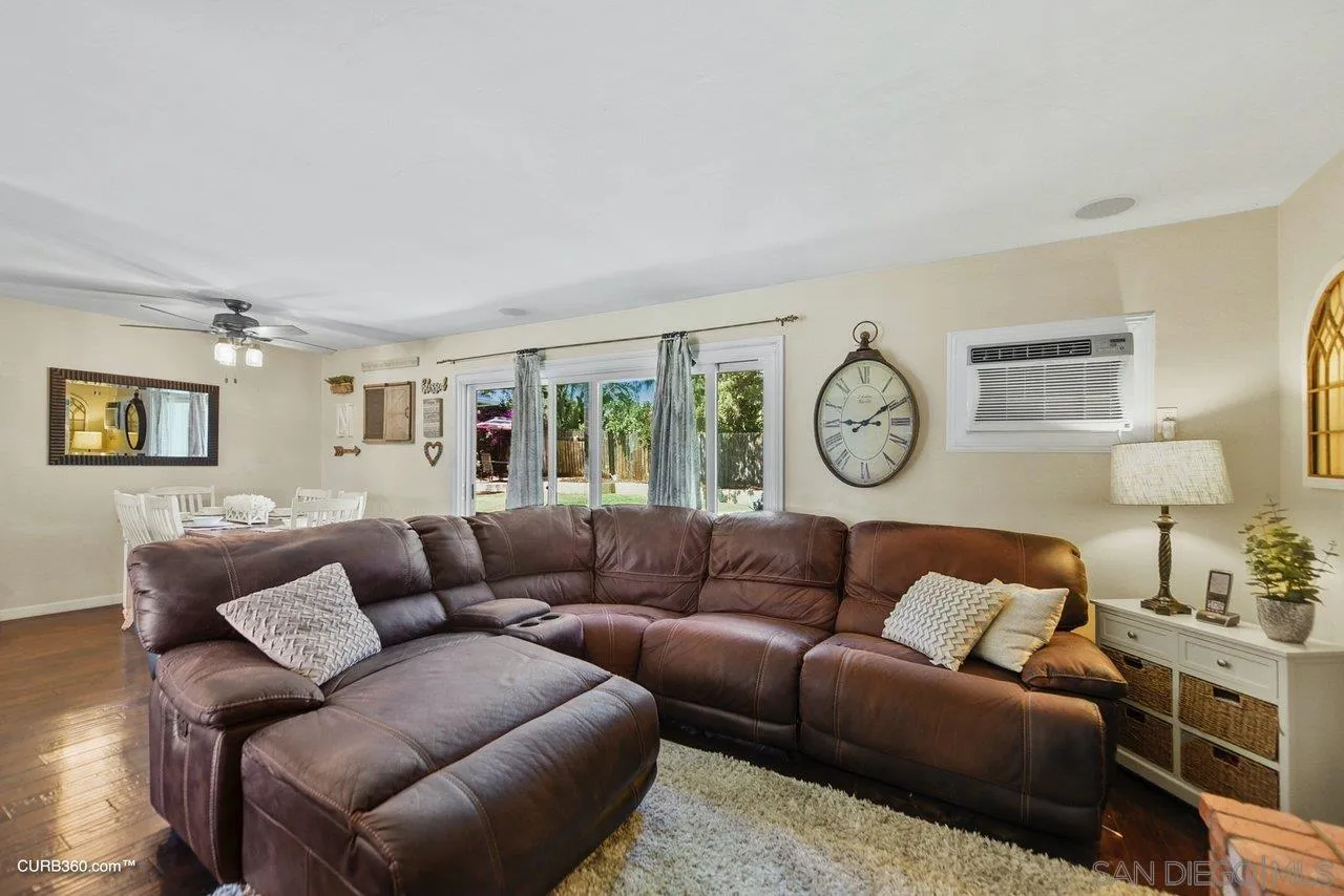 13429 Standish Drive Poway, CA 92064 - Photo 6 of 30 a living room with furniture a clock and a window