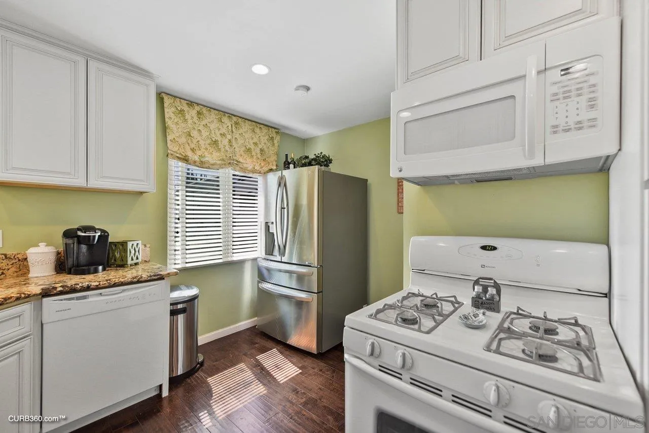 13429 Standish Drive Poway, CA 92064 - Photo 10 of 30 a kitchen with a stove a sink and a refrigerator