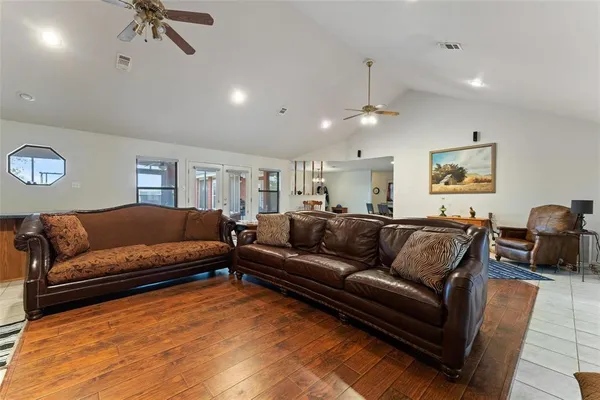 a living room with furniture and a ceiling fan