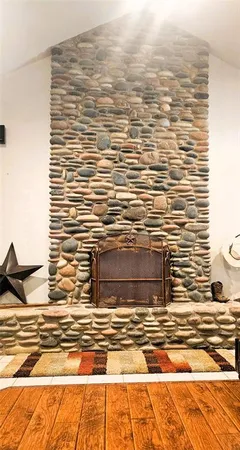 a living room with a flat screen tv and a hard wood floor