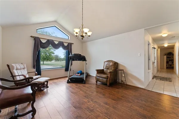 a living room with stainless steel appliances kitchen island granite countertop dining table chairs and a refrigerator