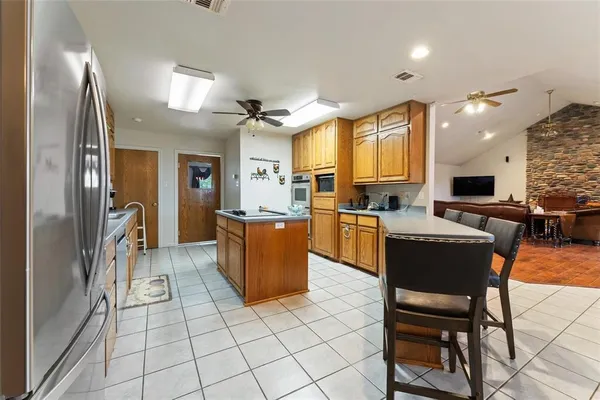a kitchen with stainless steel appliances granite countertop a stove and a microwave