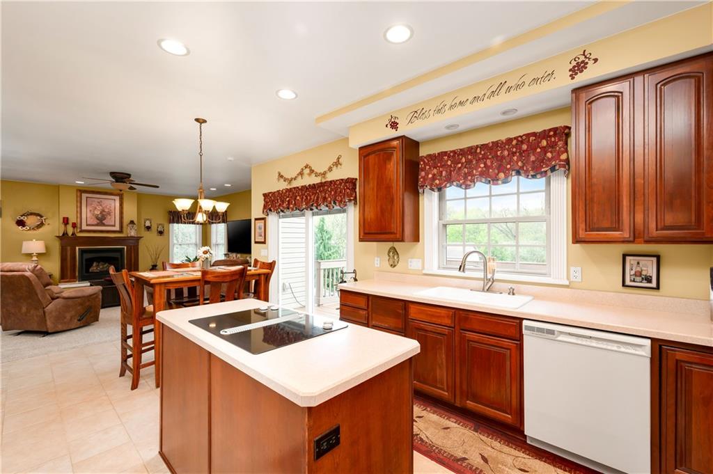 829 Hartzell School Road New Brighton, PA 15066 - Photo 6 of 50 a kitchen with a sink a counter top space a large window and stainless steel appliances