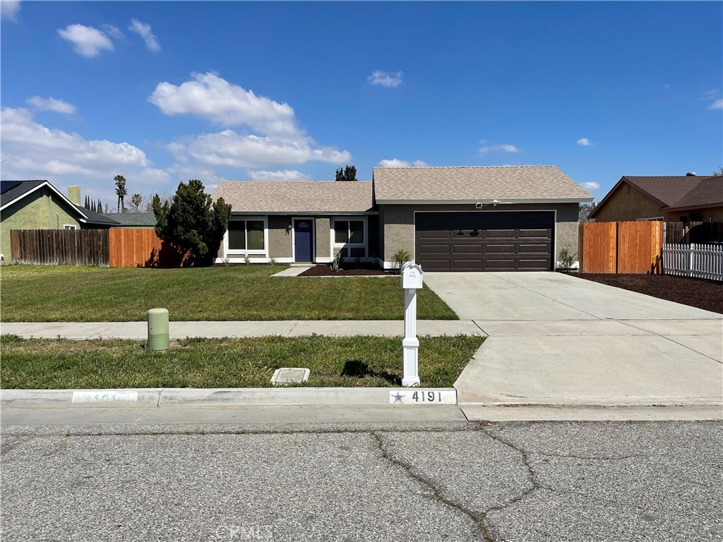 4191 Boise Street Riverside, CA 92501 - Photo 1 of 1 a front view of a house with a yard and garage