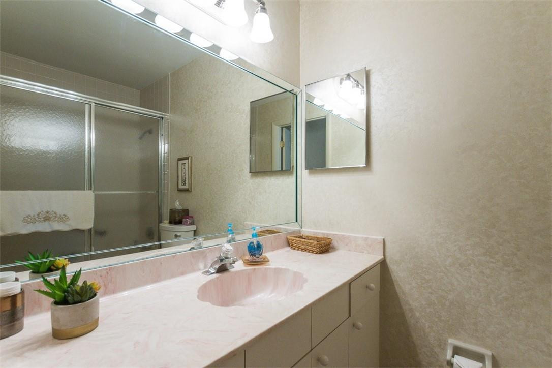 9096 Southwest 20th Street, Unit F Boca Raton, FL 33428 - Photo 21 of 35 a bathroom with a sink and a mirror