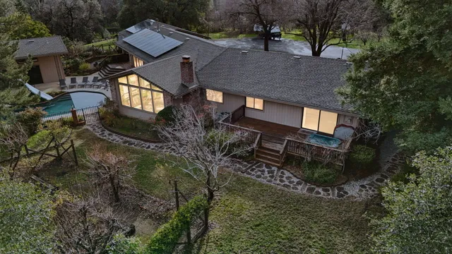 an aerial view of a house with a yard