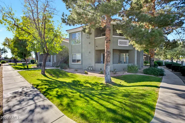 a view of a house with a yard patio and a small yard