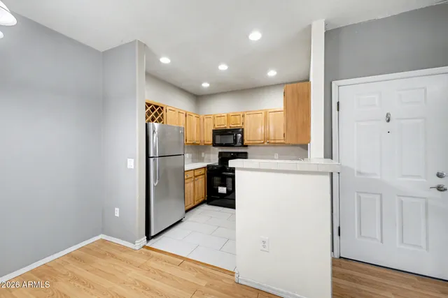 a kitchen with refrigerator cabinets and wooden floor