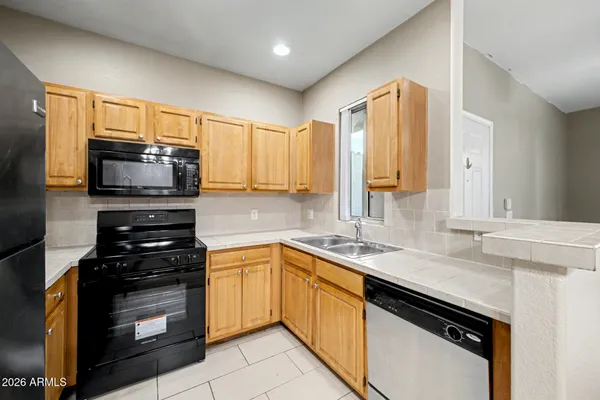 a kitchen with a sink stove and microwave