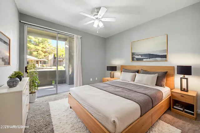 a bedroom with a balcony a bed and a chandelier