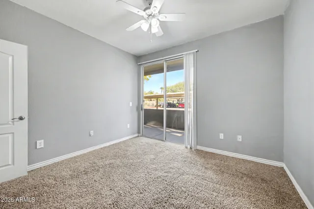 an empty room with fan and entrance