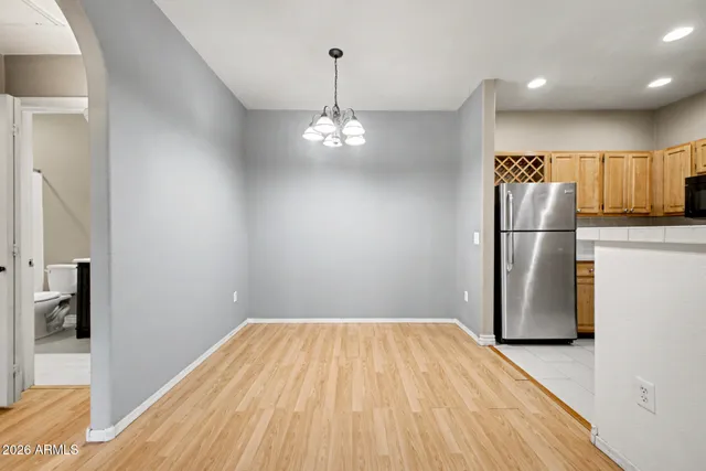 a view of a kitchen with a sink and refrigerator