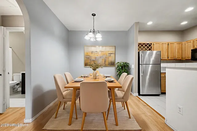 a dining room with furniture a chandelier and wooden floor