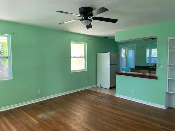 a room with a window and a ceiling fan