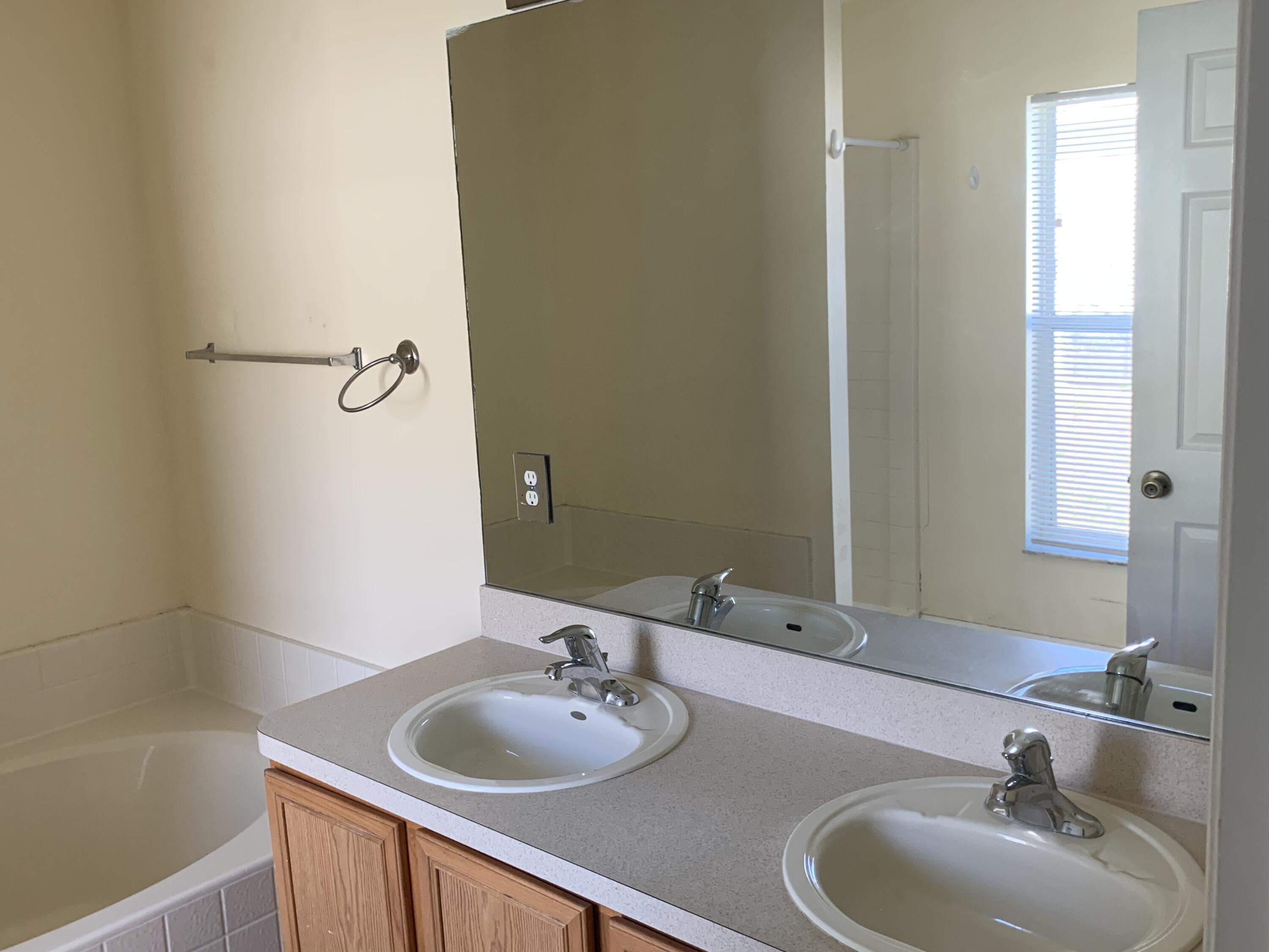 269 Southwest Ridgecrest Drive Port St. Lucie, FL 34953 - Photo 12 of 24 a bathroom with a sink and a mirror