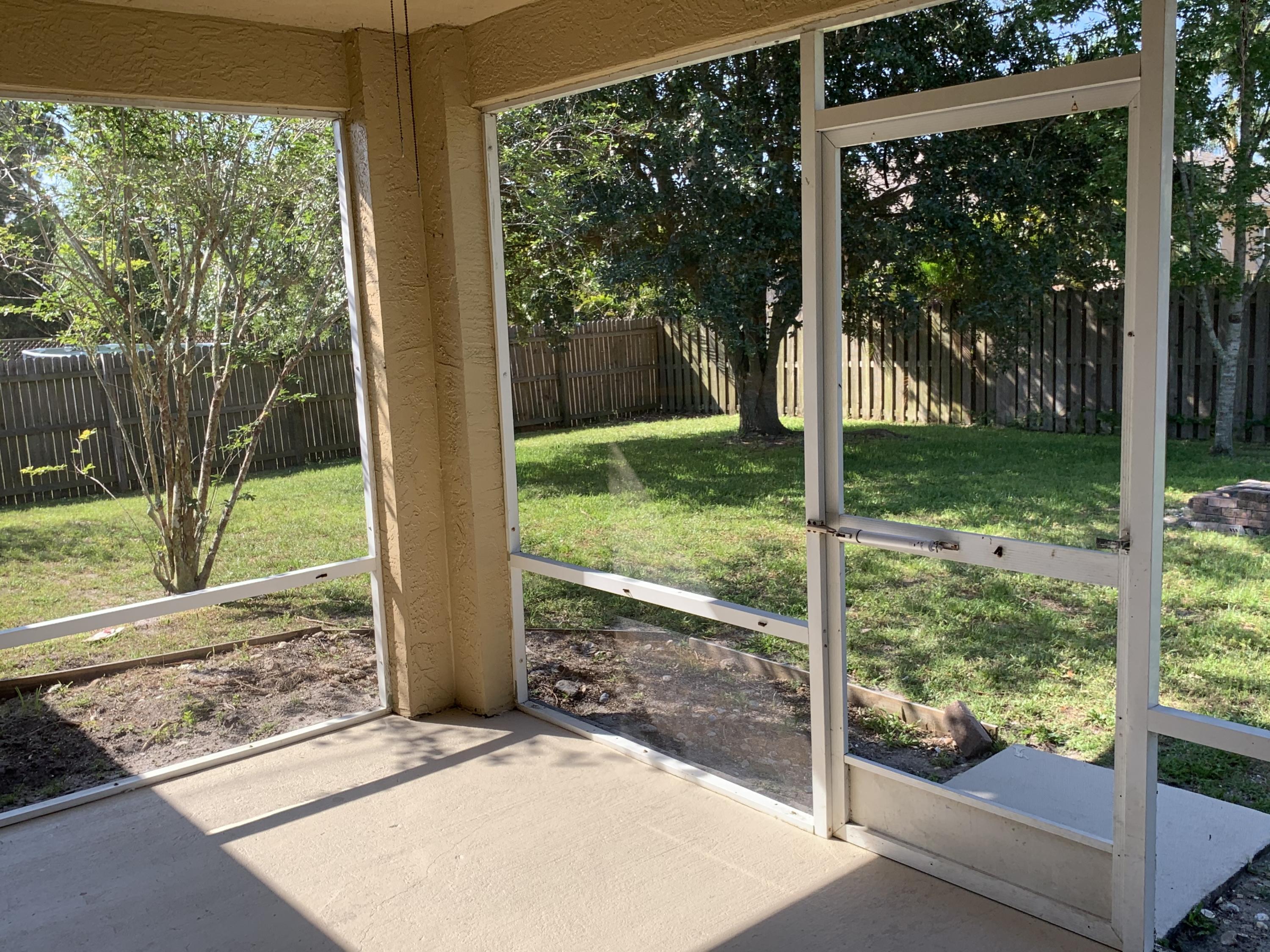 269 Southwest Ridgecrest Drive Port St. Lucie, FL 34953 - Photo 16 of 24 a view of a backyard with a garden