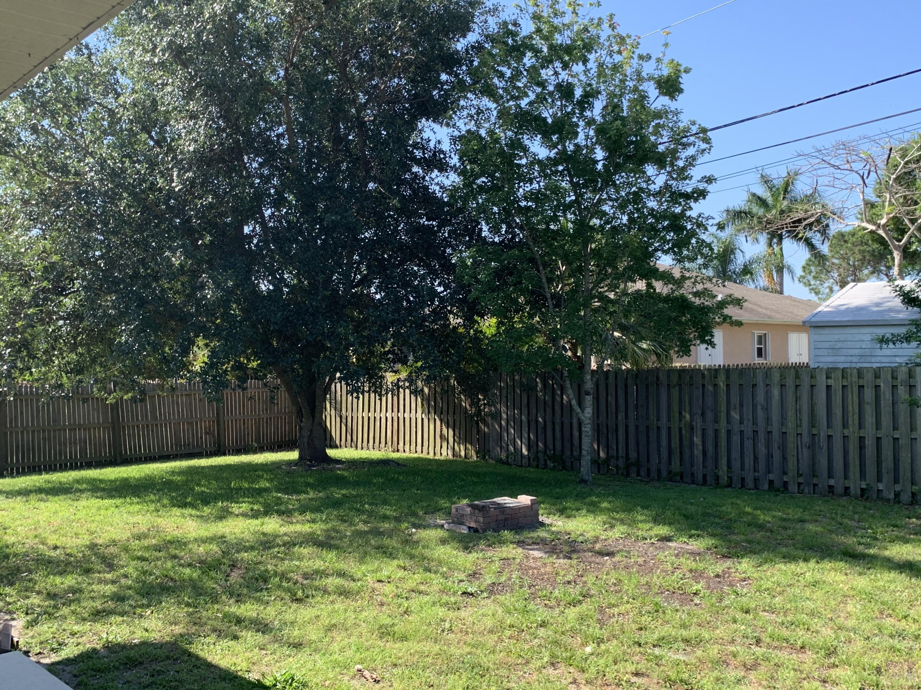 269 Southwest Ridgecrest Drive Port St. Lucie, FL 34953 - Photo 24 of 24 a backyard of a house with lots of green space