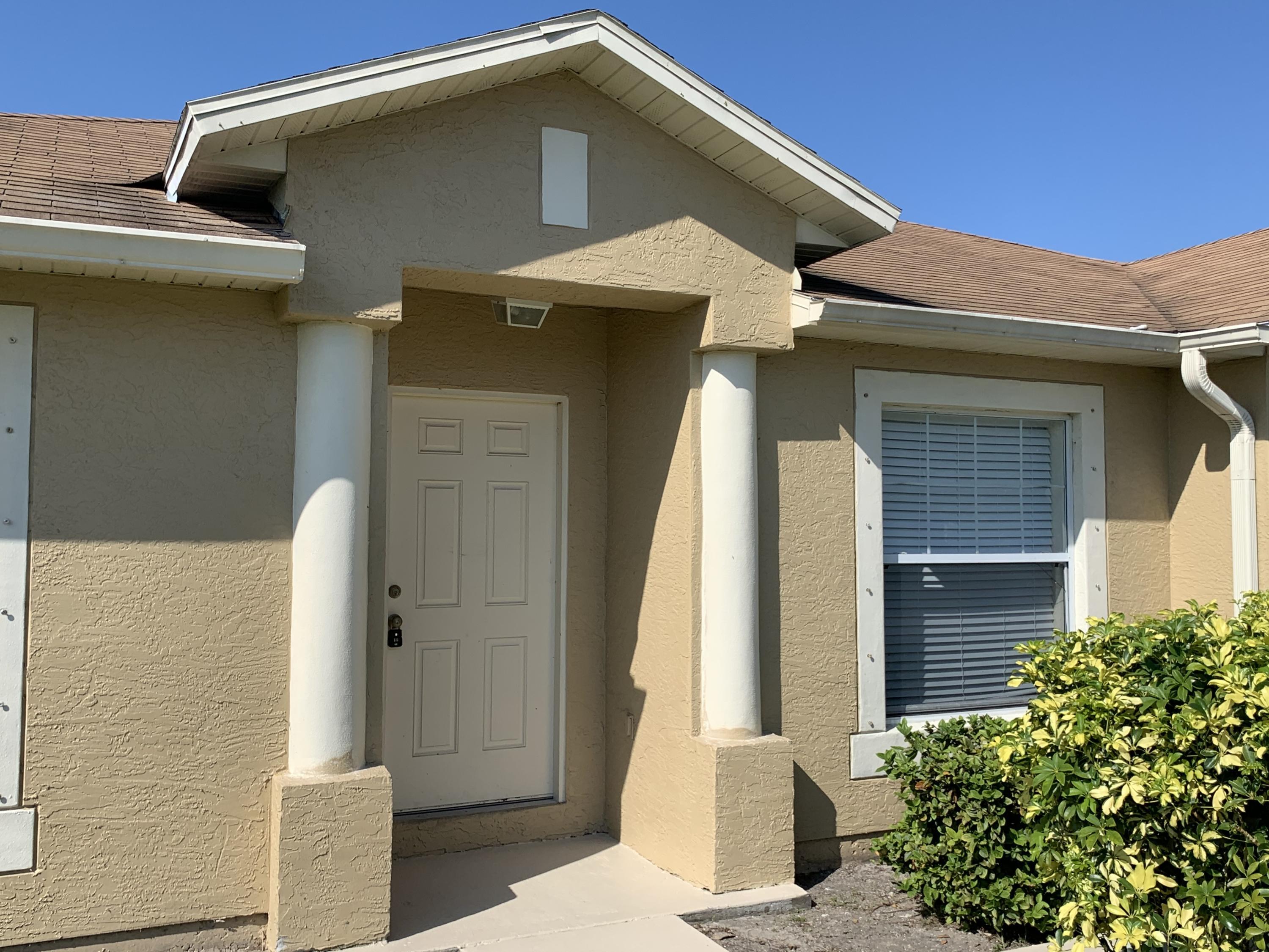 269 Southwest Ridgecrest Drive Port St. Lucie, FL 34953 - Photo 4 of 24 a front view of a house with a yard
