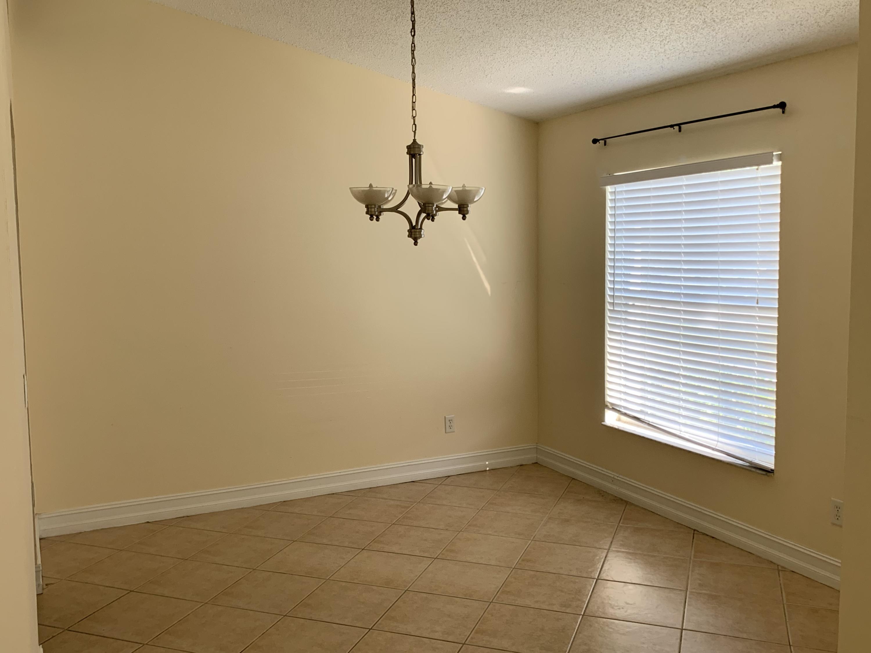 269 Southwest Ridgecrest Drive Port St. Lucie, FL 34953 - Photo 6 of 24 a view of a room with a window and a fan