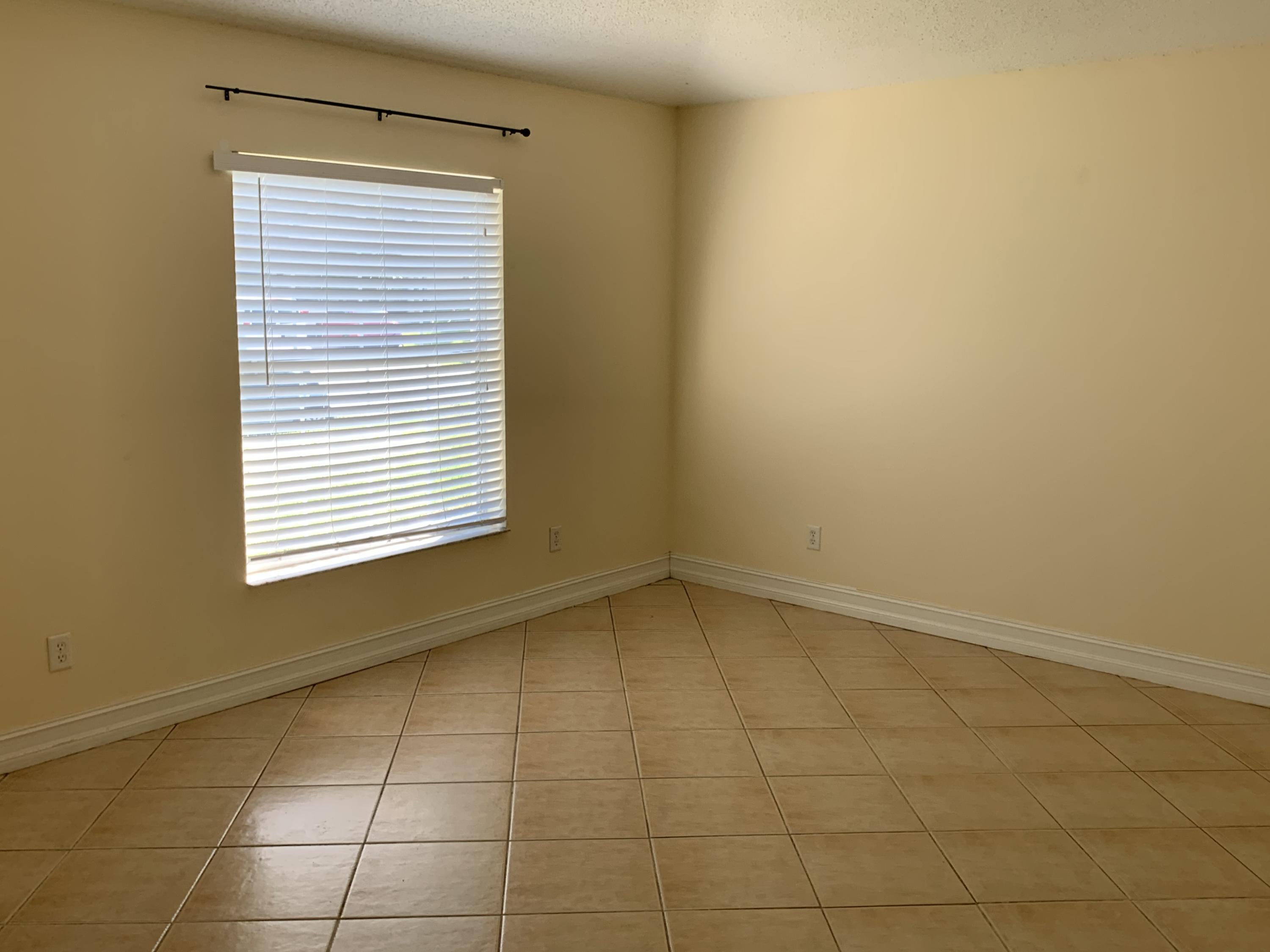 269 Southwest Ridgecrest Drive Port St. Lucie, FL 34953 - Photo 7 of 24 a view of an empty room with a window