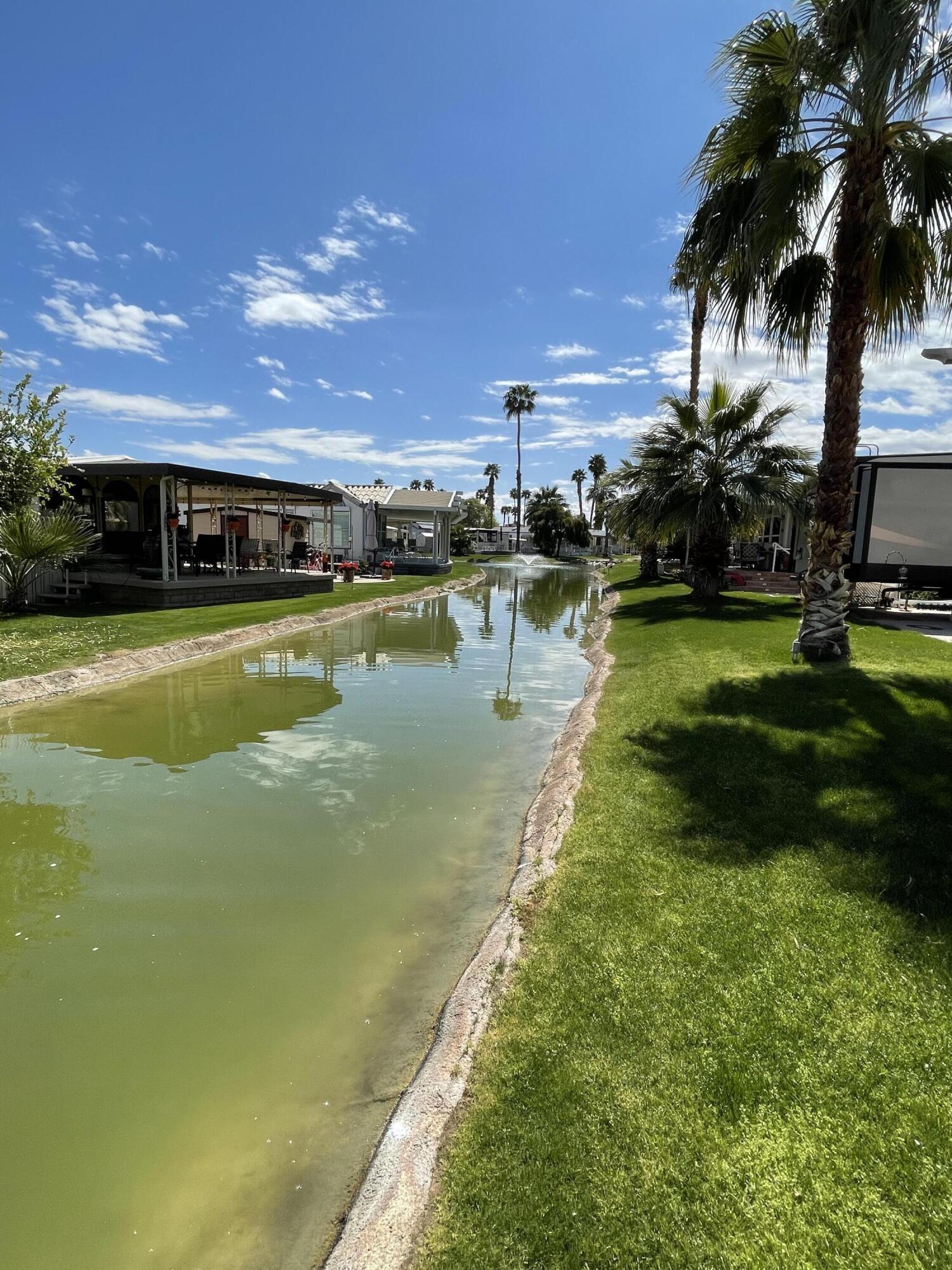 81620 Ave 49, Unit 235B Indio, CA 92201 - Photo 11 of 21 a view of a swimming pool with a garden