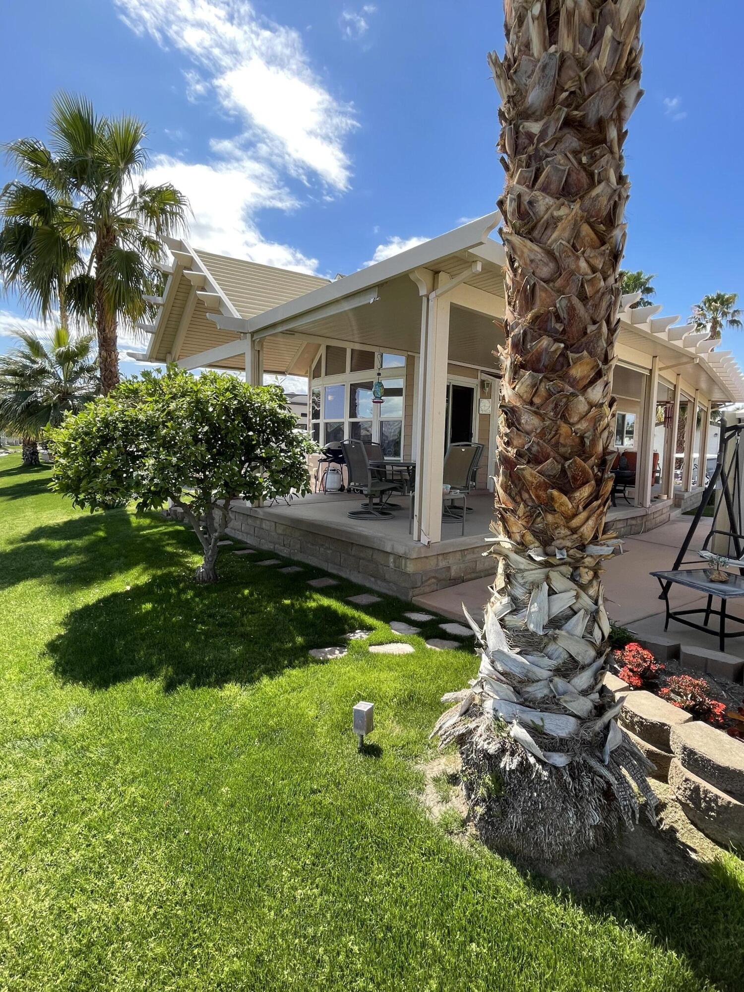 81620 Ave 49, Unit 235B Indio, CA 92201 - Photo 12 of 21 a house with a tree in front of it